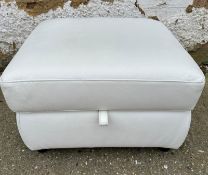 A white leather pouffe with storage compartment
