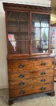 A Georgian mahogany secretaire bookcase, glazed doors opening to shelves, the base fitted with