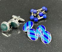 A selection of three silver cuff links to include blue striped enamel pair.