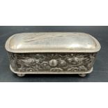A Chinese silver hairpin or hat pin box decorated with dragons and on four small feet, makers mark