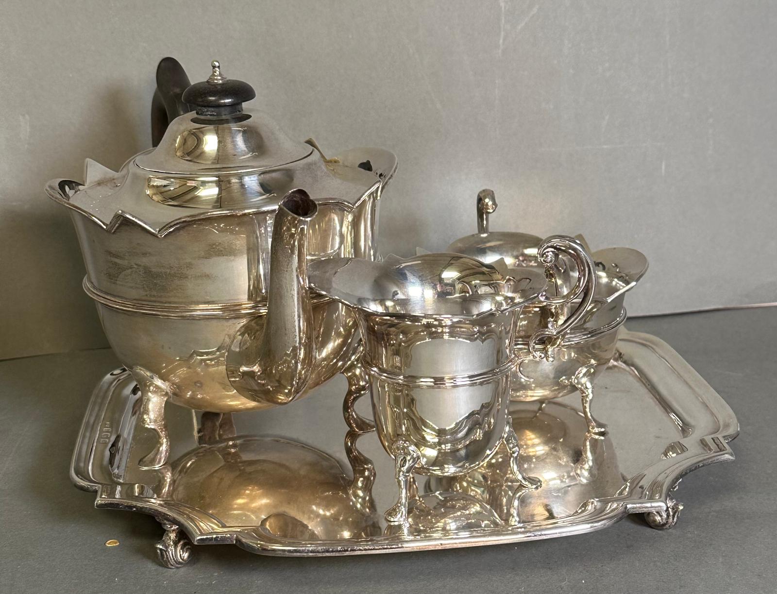 A three piece silver tea service to include a teapot, milk jug, and sugar bowl by Watson & Gillott