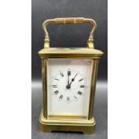 A French brass cased carriage clock with glass panes to side and back
