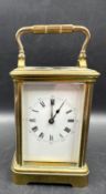A French brass cased carriage clock with glass panes to side and back
