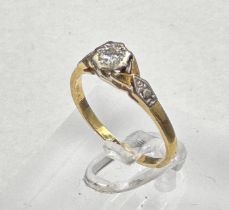 An 18ct and platinum set diamond ring with central stone and shoulders Size M