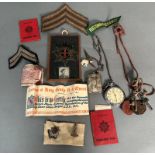 A selection of WWII ephemera, cap badges, whistle, insignia, pocket watch etc.