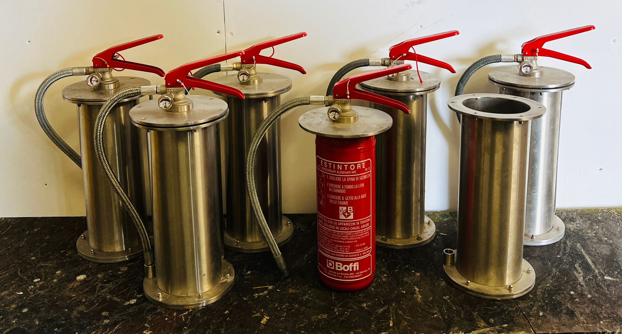 Six floor extinguishers in a stainless steel carcass by Boffi
