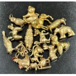 A selection of fifteen 9ct gold charms featuring a wide variety of characters with a combined