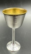 A brass and silvered small cup with elephant and crown motif.