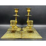 Two pairs of ornate brass candlesticks