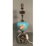 A table lamp with blue ceramic florally painted bowl on a brass floral base