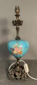 A table lamp with blue ceramic florally painted bowl on a brass floral base