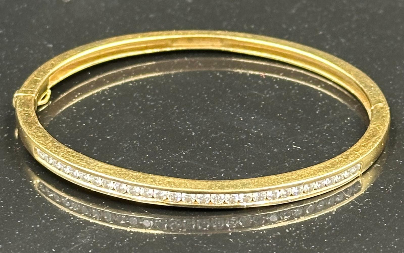 Channel set diamond bangle mounted in 18ct gold. Signed Tiffany & Co. Total diamond weight