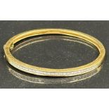 Channel set diamond bangle mounted in 18ct gold. Signed Tiffany & Co. Total diamond weight