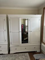 A white three door wardrobe with three drawers below and hanging space above (H200cm W165cm D55cm)