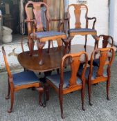 A mahogany dining table with twin pedestal and eight chairs (H75cm W183cm D112cm with three leaves