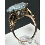 A 14ct aquamarine ring with floral motif shoulders, approximate total weight 4.4g. Size M