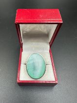 A silver and jade ring, approximate size Q.