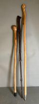 Three wooden carved and whittled walking sticks various woods