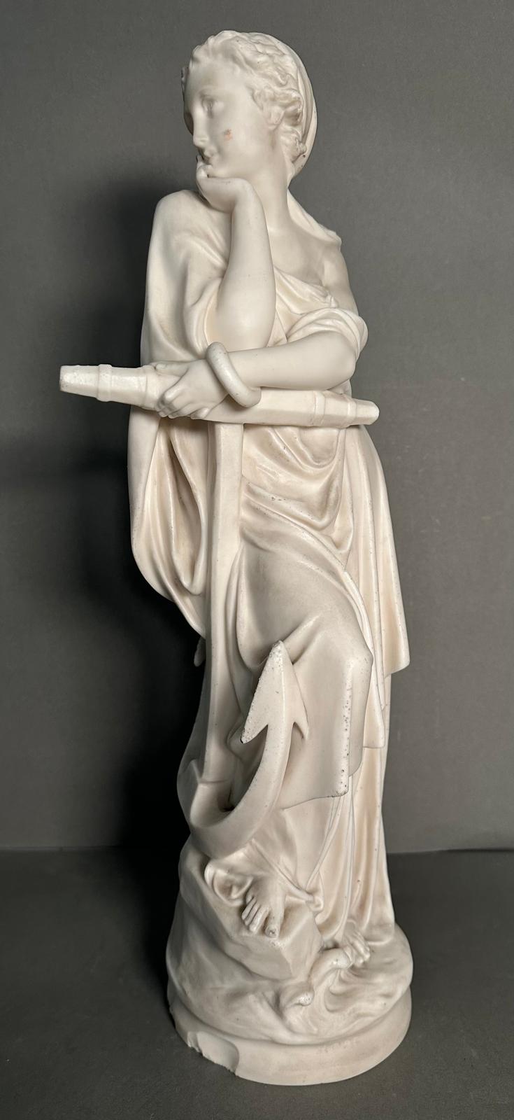A statue of a classical figure resting on an anchor, approximate 45cm.