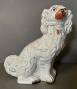 A large 19th Century Staffordshire spaniel in white and gold