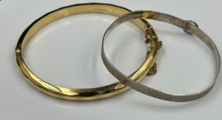 A rolled gold bracelet and a sterling silver christening style bracelet.