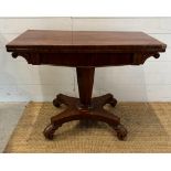A Regency style mahogany fold over tea table with hexagonal central support terminating on four