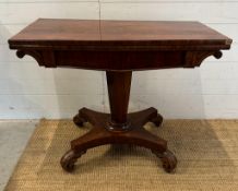 A Regency style mahogany fold over tea table with hexagonal central support terminating on four