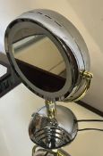 A black lit swivel makeup mirror
