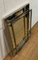 A contemporary wall mirror with a geometric chrome framed 86cm x 116cm
