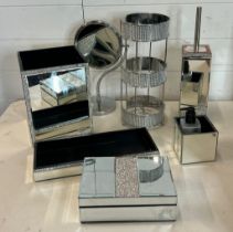 A collection of mirrored bathroom accessories