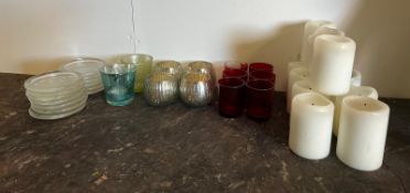 A selection of T-Light holders and used candles with glass holders