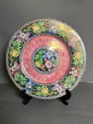 A maling plate with floral relief
