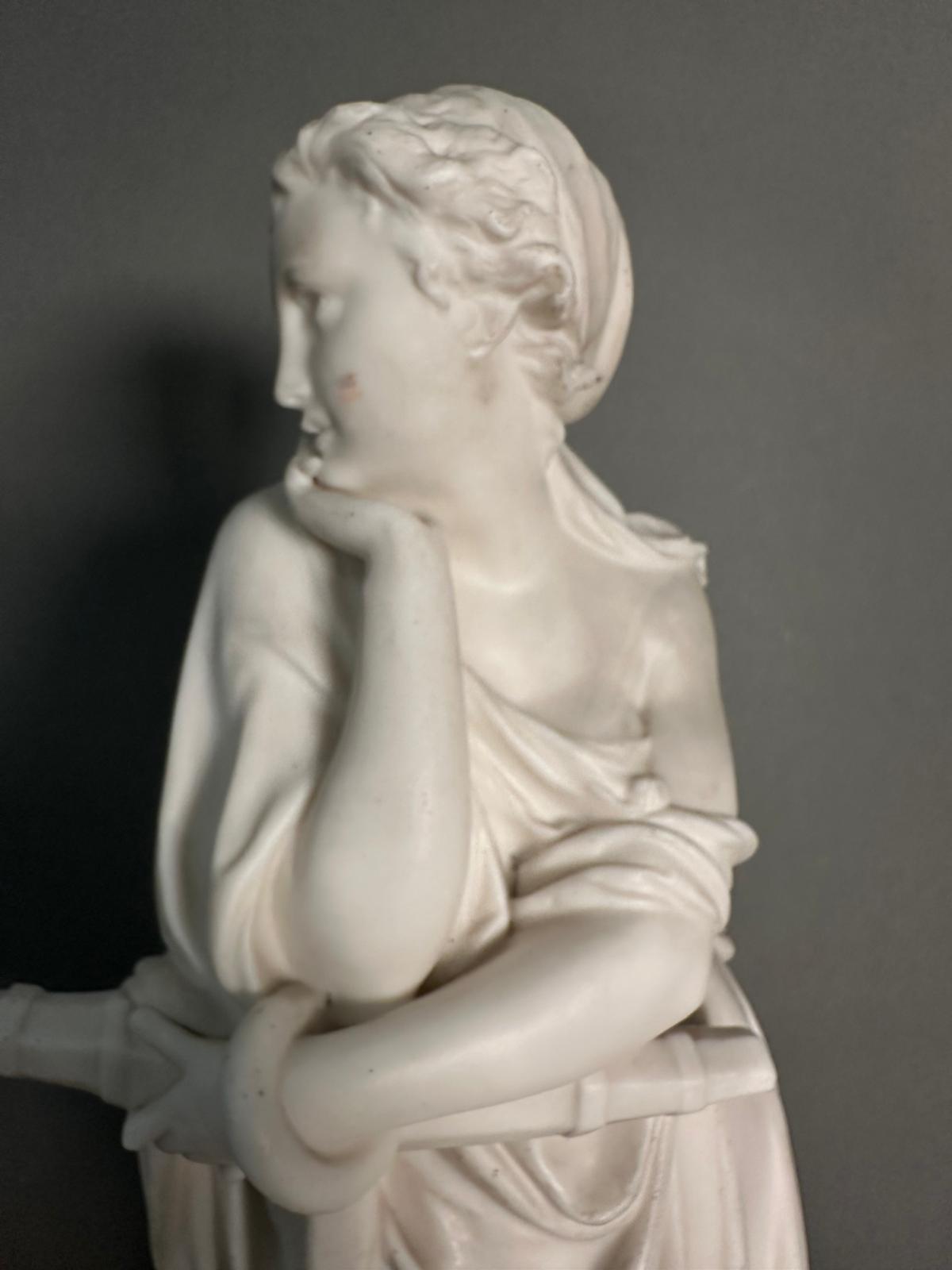 A statue of a classical figure resting on an anchor, approximate 45cm. - Image 2 of 4