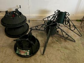 Five Christmas tree stand, three plastic and two metal