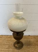 A brass and ribbed glass oil lamp