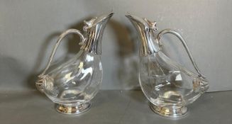 A pair of duck shaped, silverplated decanters