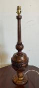 An African style wooden carved table lamp with a lion banded relief