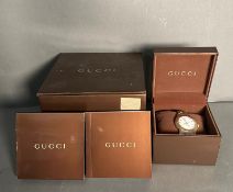 A Gucci watch in original box with manual but watch is missing its back.