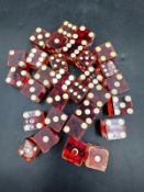 A selection of croupiers or casino style red resin dice.