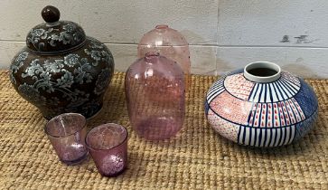 A collection of decorative items including lidded jar and vases