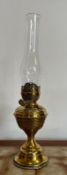 A Victorian brass oil storm lamp with clear glass tulip shade