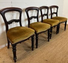 A set of four mahogany Victorian dining chairs upholstered in green