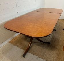 A single leaf mahogany extendable dining table on pedestal tripod legs and brass lion paws feet (
