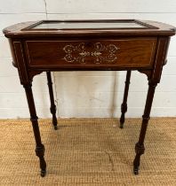 A Victorian bijouterie table with string and scrolling floral inlay on turned legs and casters