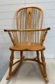 A pine high back Windsor rocking chair