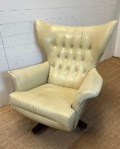 A G-Plan wing backed white leather arm chair on a swivel base