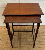 A nest of two mahogany side tables with inlaid tops