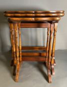 A nest of three regency style tables on turned supports