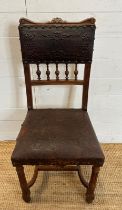 A French oak and embossed leather hall chair, turned front legs and ornate floral pattern to seat