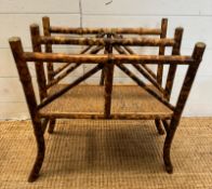 An Edwardian bamboo canterbury with brass fitting